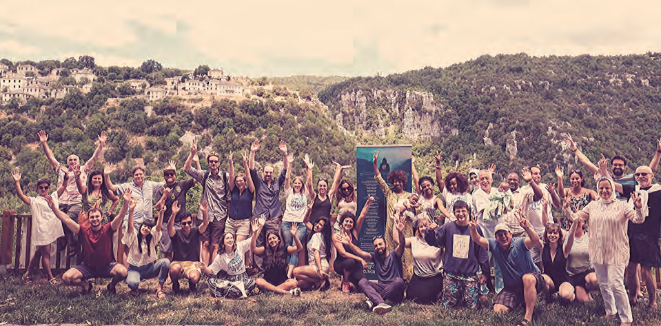 A crowd of young climate activists cheers on a hillside