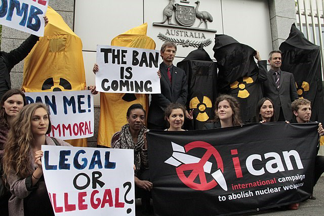 Campaigners hold banners reading The Ban Is Coming at an ICAN demonstration against nuclear weapons