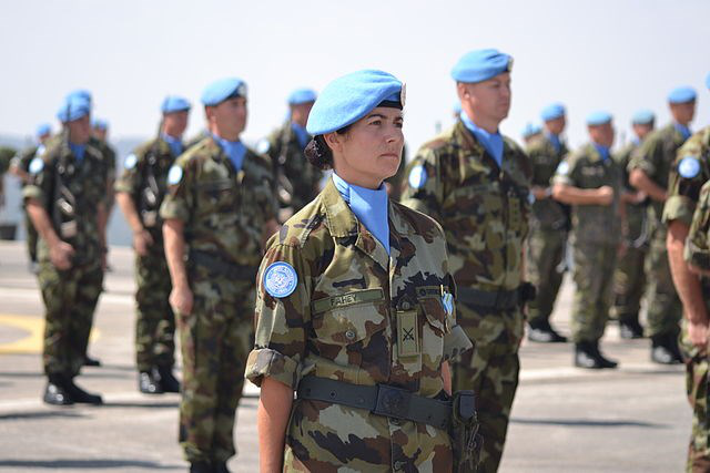 United Nations peacekeepers in blue berets standing in formation