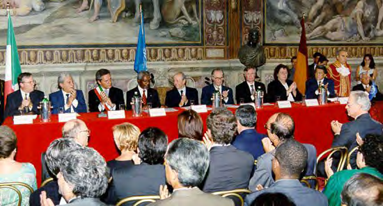 Delegates seated at a long table during an international treaty conference in an ornate hall