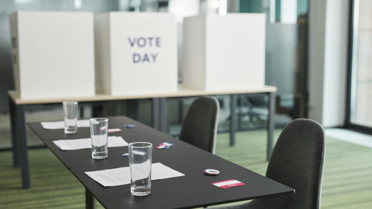 A modern office setting with a table and chairs arranged for voting purposes, emphasizing the importance of democratic p