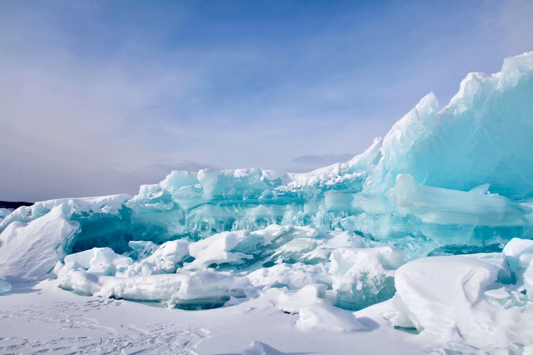 A large formation of ice and snow on a beach.