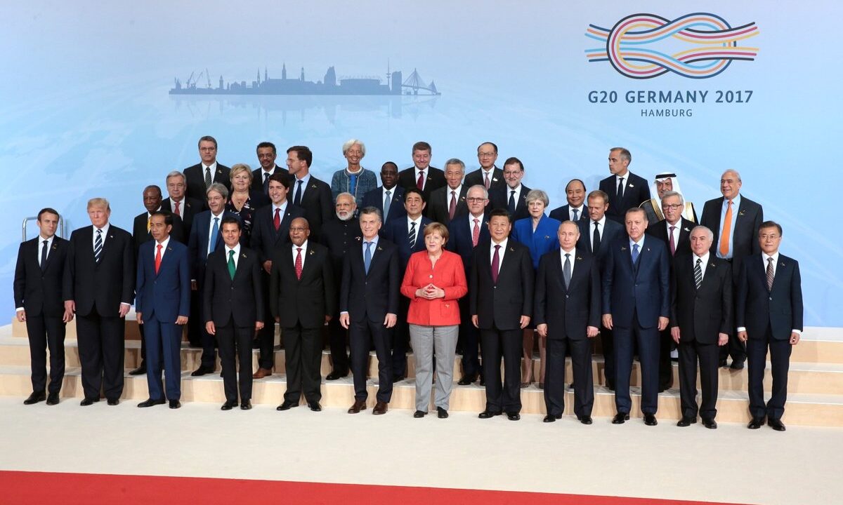 World leaders assembled for a group photo at a major multilateral summit, illustrating an alliance of states acting jointly to defend international rules.
