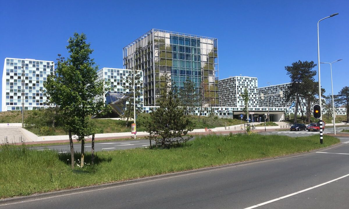 The International Criminal Court premises in The Hague, seen from across the approach road, a clean daylight establishing shot of the institution whose mid-2019 caseload this update summarizes.