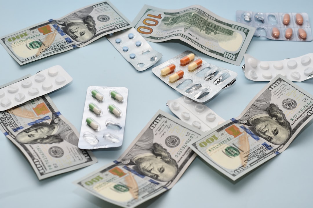 Blister packs of pharmaceutical pills arranged with US one-hundred-dollar bills