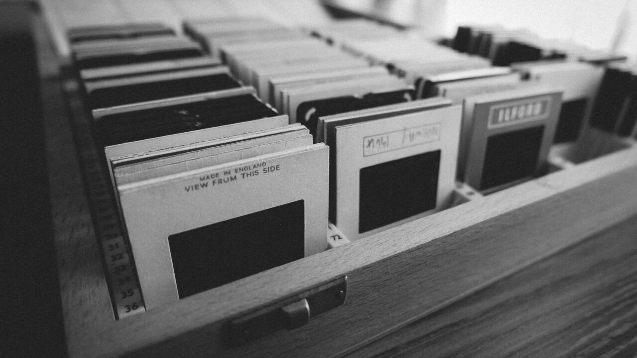 A collection of business cards in a wooden holder, suggesting a professional or corporate setting.