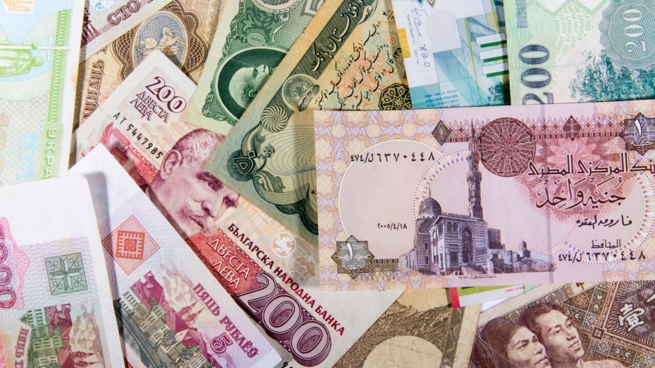 A collection of various international banknotes, representing different countries and denominations.