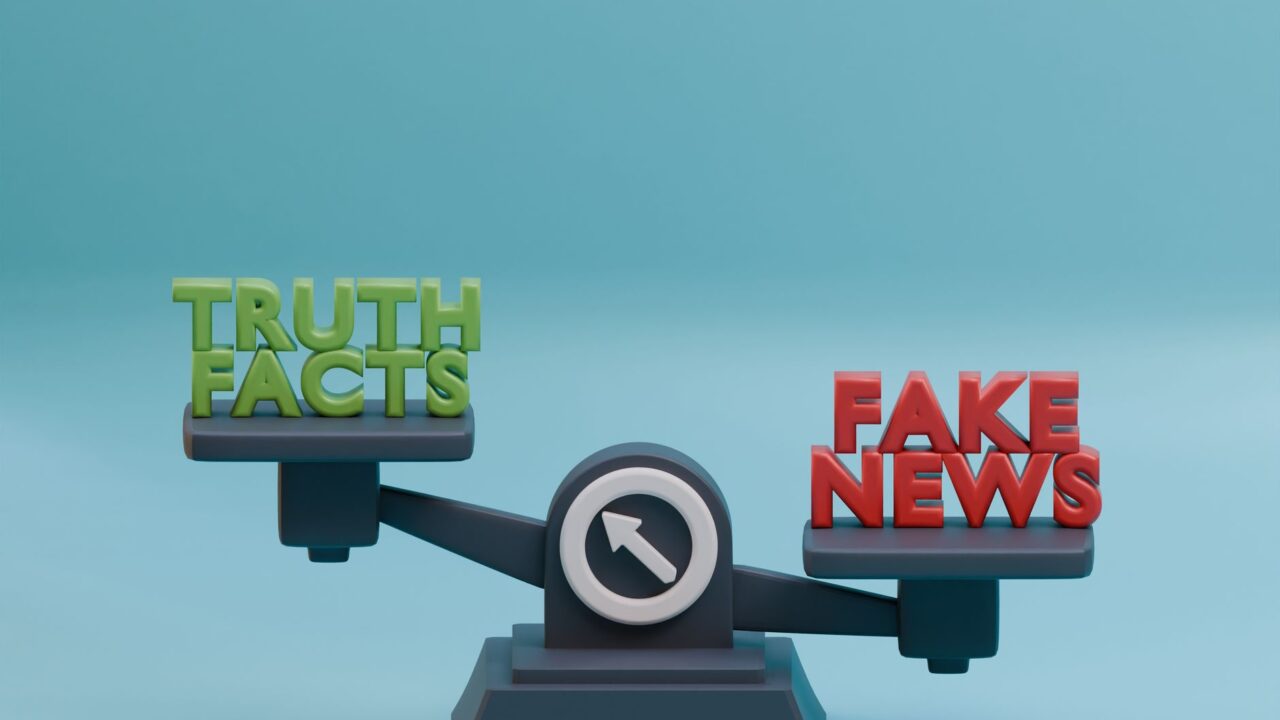 A scale weighing the concepts of truth and fake news, symbolizing the importance of verifying information sources.