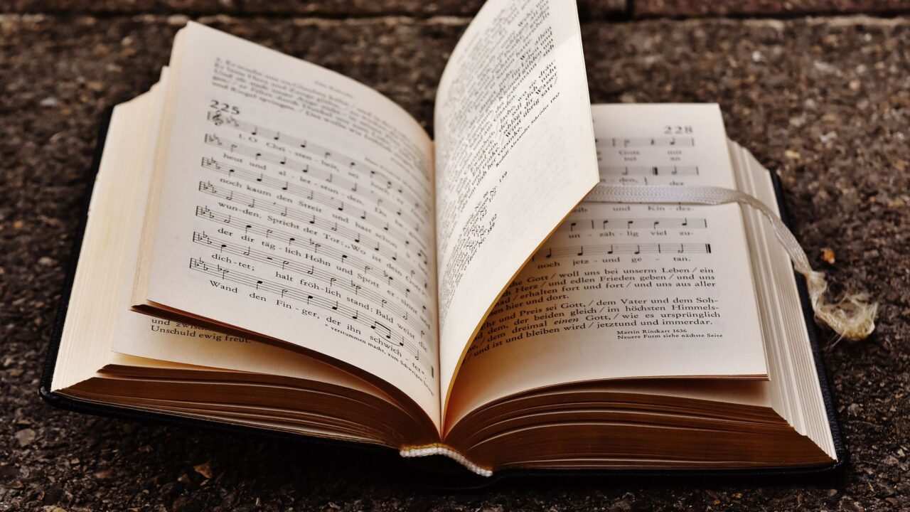 An open book with sheet music, suggesting a connection between music and literature.