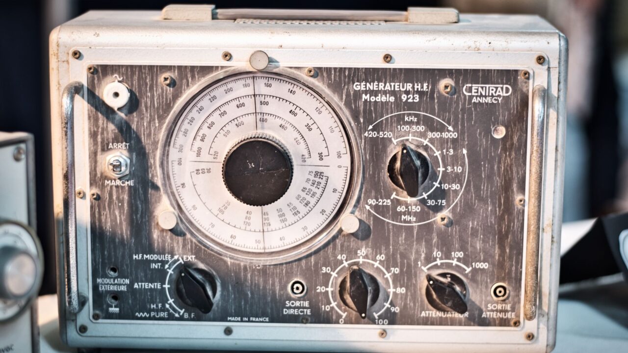 An old-fashioned analog instrument, possibly a radio or scientific device, with dials and gauges.