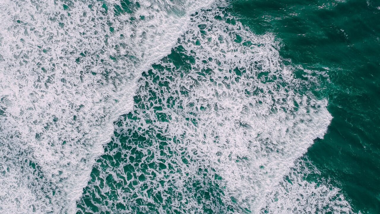 The image captures the dynamic movement of ocean waves, showcasing the raw power and beauty of nature.