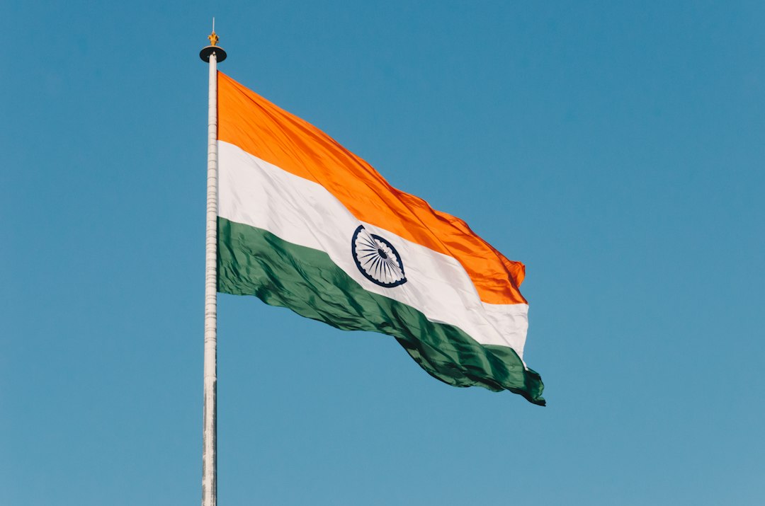 The flag of India, the Tiranga, is waving in the breeze, symbolizing national pride and identity.