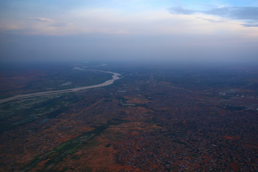 An aerial view of a river winding across dry plains at dusk.