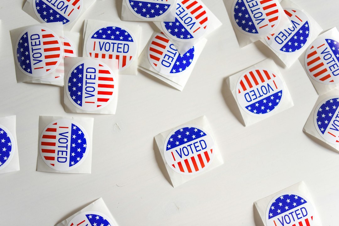 Close-up of several American voting stickers with the word 'Voted' printed on them.