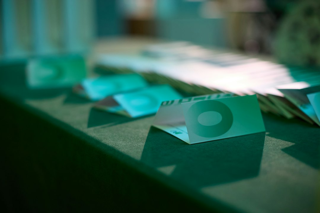 A collection of business cards and documents on a table, suggesting a professional or corporate setting.