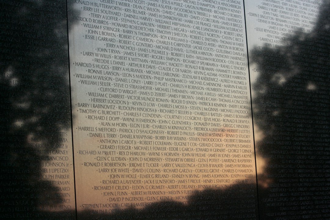 The photograph shows a wall of names, likely at a memorial site dedicated to honoring individuals who have made signific