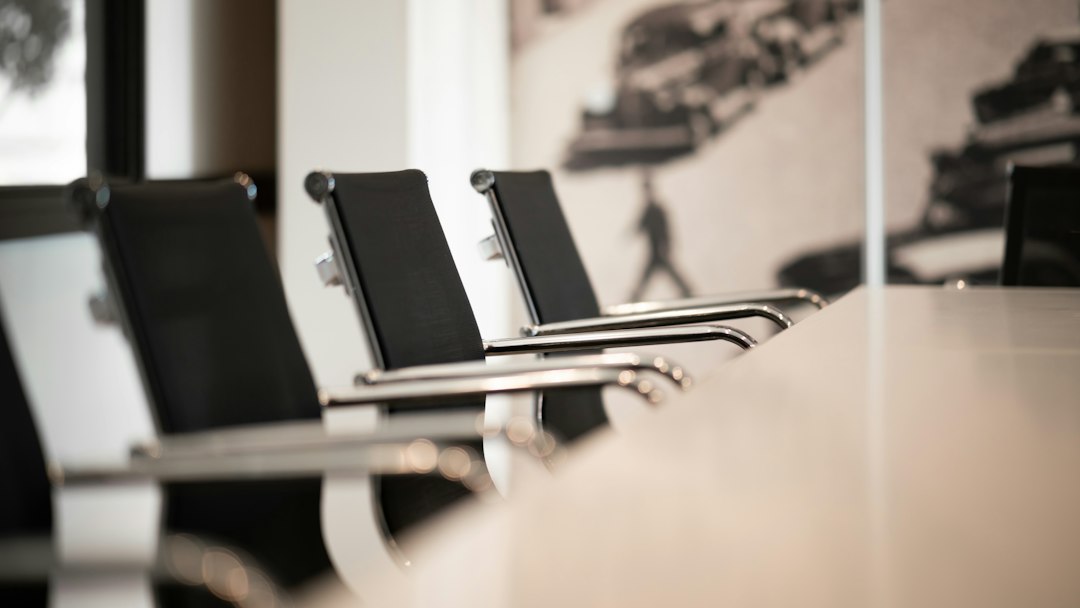 A professional setting with a long table and chairs, suggesting a business meeting or conference.